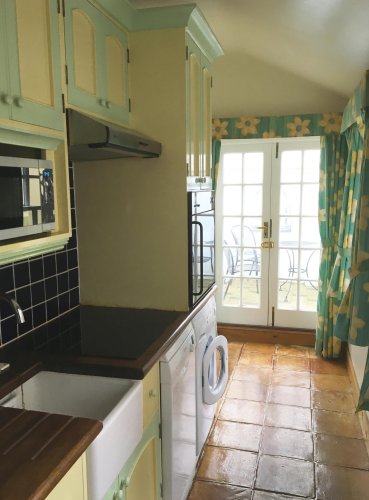 The Kitchen leads to French doors which open onto the courtyard, with Southwold Lighthouse just yards away.